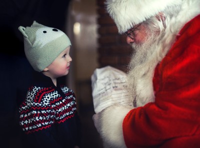 small boy talking to Santa