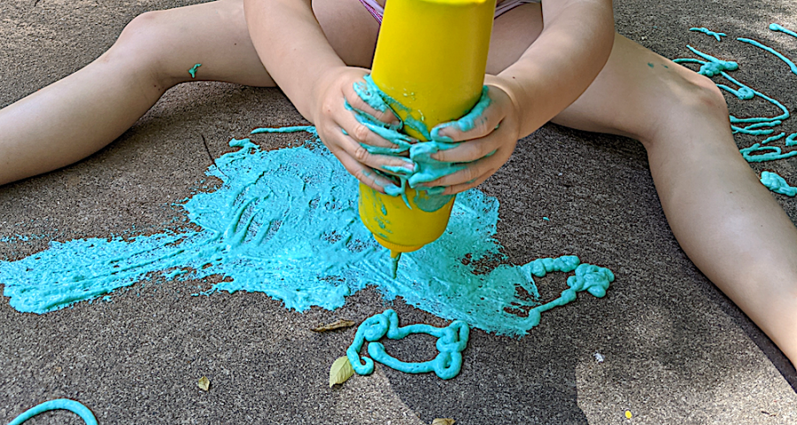 teal fluffy paint being squeezed