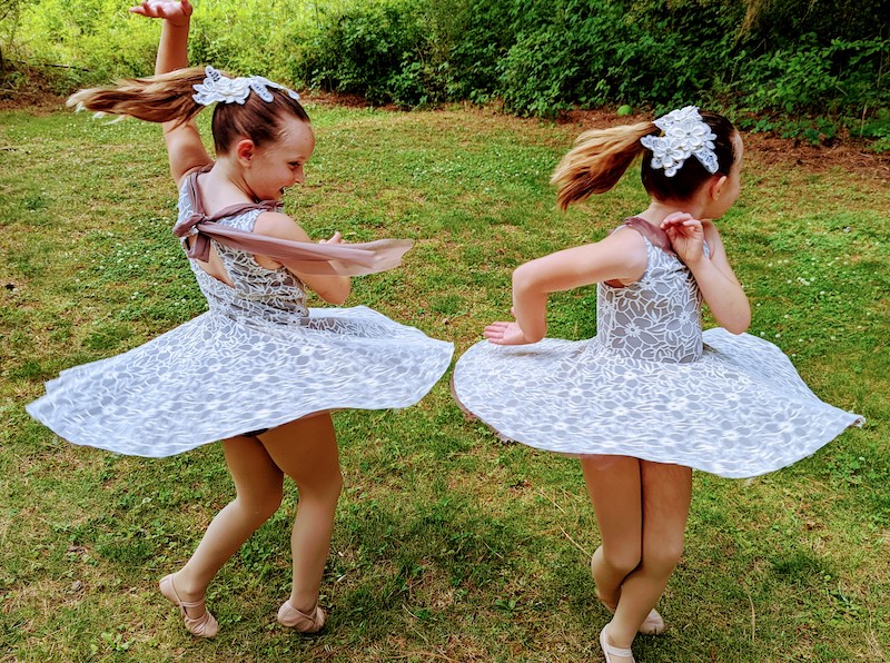 two little girls twirling