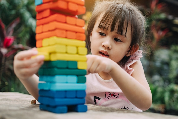 girl playing with colorful blocks